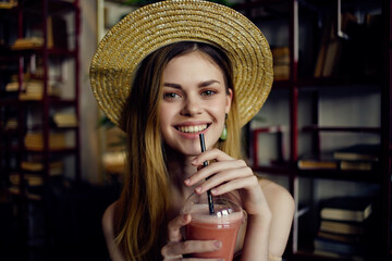 pretty woman sitting at a table with a drink in a cafe fashion