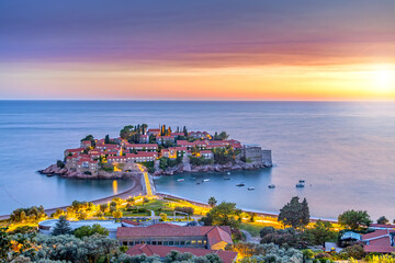 view of beauty sunset over Sveti Stefan, small islet and resort in Montenegro. Balkans, Adriatic sea, Europe. © stoimilov