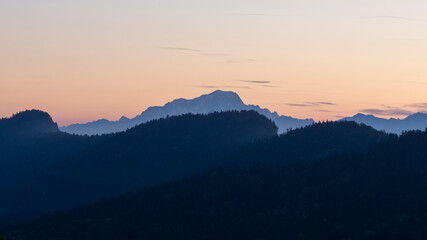 Layers of mountains and orange sky at sunrise