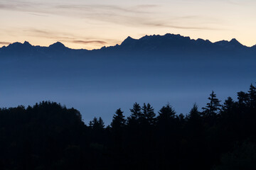 Forest and silhouette of mountains in the morning