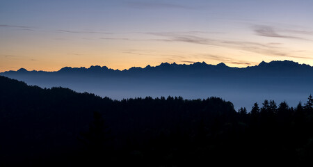 Forest and silhouette of mountains in the morning