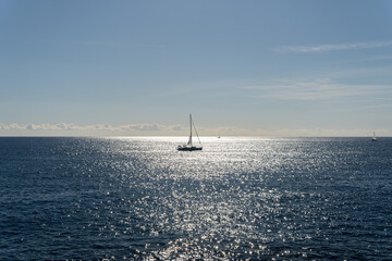 Seascape of the Mediterranean Sea at sunrise with a ship sailing in its waters. Sublime landscape of a sunrise from the island of Mallorca, Spain