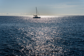 Seascape of the Mediterranean Sea at sunrise with a ship sailing in its waters. Sublime landscape...