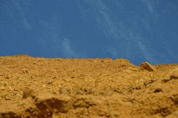 hill with blue sky, clay