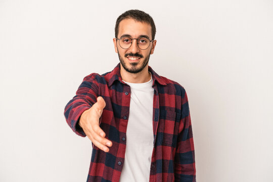 Young caucasian man isolated on white background smiling and raising thumb up