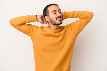 Young caucasian man isolated on white background feeling confident, with hands behind the head.