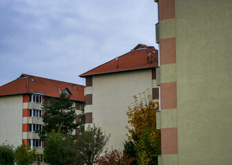 Renewed, isolated apartment building blocks in Romania at autumn on a cloudy day.
