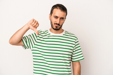 Fototapeta premium Young caucasian man isolated on white background showing thumb down, disappointment concept.