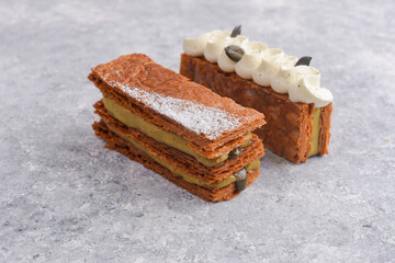 Two Mille-feuille desserts with caramel, vanilla cream and pumpkin seeds