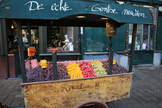 Ghent, Belgium - October 9. 2021: Closeup of wooden vintage cart at store front with colorful typical gentse cuberdon neuzen (focus on cart)