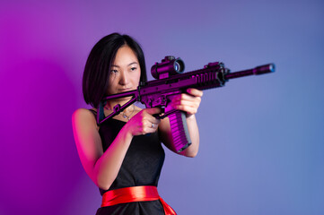 asian woman with a machine gun aims for shooting