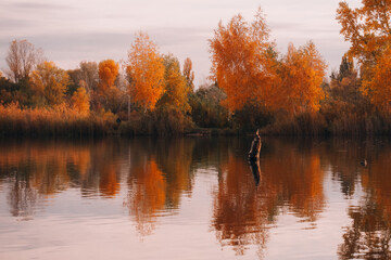 autumn trees reflected in water