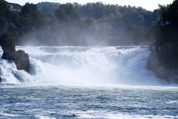 Famous Rhine Falls with rocks and trees on a beautiful autumn day. Photo taken September 25th, 2021, Zürich, Switzerland.