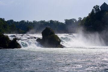 Famous Rhine Falls with rocks and trees on a beautiful autumn day. Photo taken September 25th, 2021, Zürich, Switzerland.