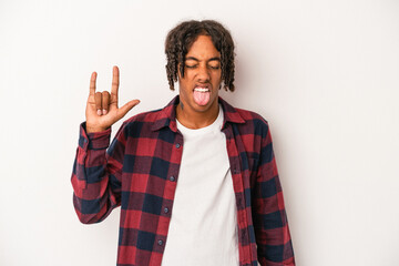 Young african american man isolated on white background showing rock gesture with fingers