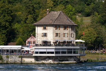Fototapeta na wymiar Restaurant at natural pool of Rhine falls on a sunny autumn day. Photo taken September 25th, 2021, Neuhausen am Rheinfall, Switzerland.