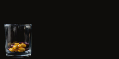 Capsule antibiotic and on a black background.