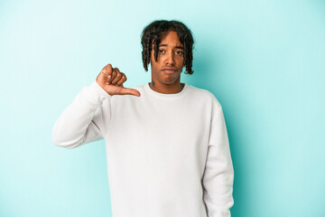 Young african american man isolated on blue background showing a dislike gesture, thumbs down....