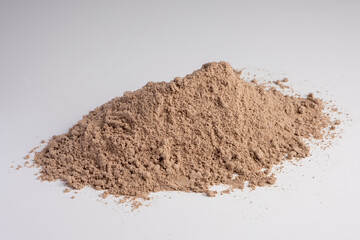 Fototapeta na wymiar Raw flax seeds flour on white background.