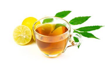 Neem tea in transparent glass with neem leaf and lemon isolated on white background.
