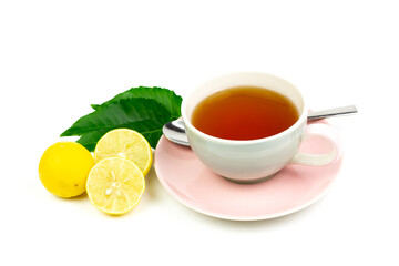 Neem tea in ceramic cup with neem leaf and lemon isolated on white background.