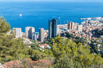 Fototapeta premium Aerial view of Monaco with skyscrapers and blue sea