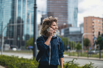 Young woman using mobile phone in the city  