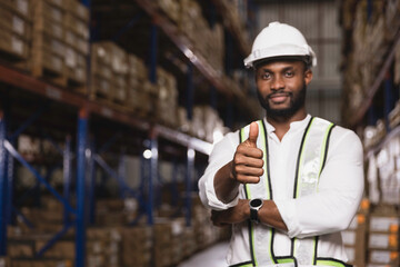 Portrait of confidence logistic warehouse black male staff worker thumbup in safety suite