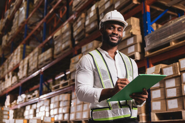 Black male staff smiling working check stock in logistic warehouse