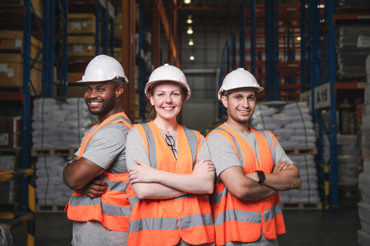 Group of smiling worker standing together at logistic distribution warehouse, Teamwork concept