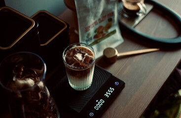 ice latte coffee in glass with digital scale and golden spoon