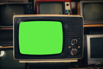 Vintage old  TV with green screen in room.