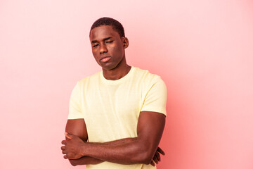 Young African American man isolated on pink background unhappy looking in camera with sarcastic expression.