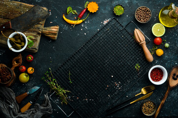Black stone background with vegetables and spices.Top view. Rustic style.