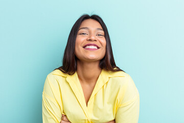 Fototapeta premium Young Venezuelan woman isolated on blue background laughing and having fun.
