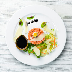Salmon tartare: Raw salmon, avocado purple onion. Top view. Food. Rustic style.