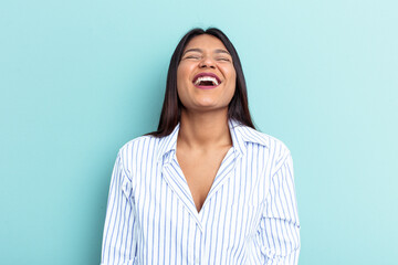 Young Venezuelan woman isolated on blue background relaxed and happy laughing, neck stretched showing teeth.