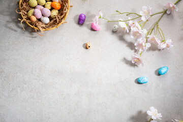 Fototapeta na wymiar Overhead view of Easter chocolate eggs and flowers