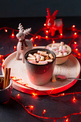 Hot chocolate beverages with marshmallow and holidays lights, holiday concept