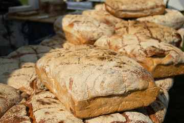 Loaves of bread lying on the counter. Sale of flour products. Breads. Products at the fair