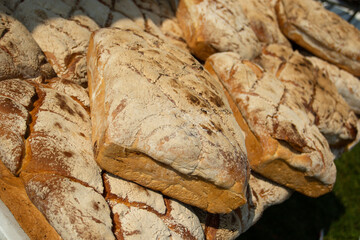 Loaves of bread lying on the counter. Sale of flour products. Breads. Products at the fair