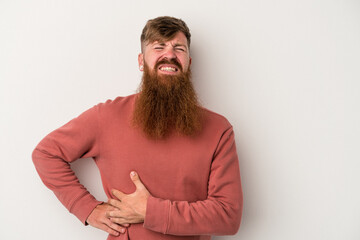 Fototapeta premium Young caucasian ginger man with long beard isolated on white background having a liver pain, stomach ache.