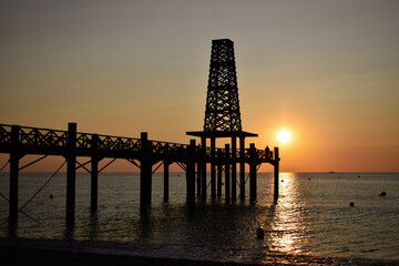 Fototapeta na wymiar sunset at the pier on the beach