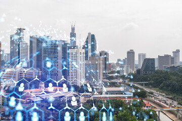 Social media icons hologram over panorama city view of Kuala Lumpur, Malaysia, Asia. The concept of people networking, connections and career opportunities. Double exposure.