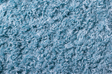 Fototapeta na wymiar Texture of the surface pile of a blue carpet