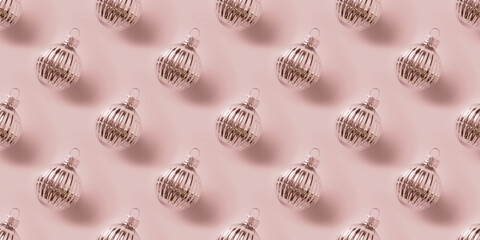 Seamless pattern of Christmas shiny silver baubles on pink background. Xmas abstract background.