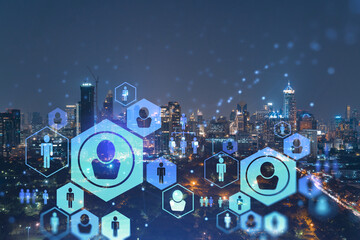 Fototapeta premium Glowing social media icons on night panoramic city view of Bangkok, Southeast Asia. The concept of networking and establishing new connections between people in businesses. Double exposure.