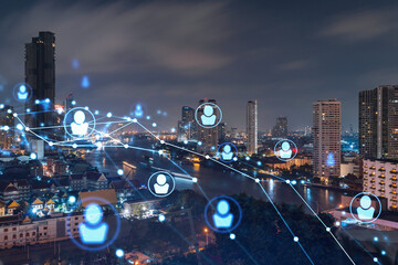 Glowing social media icons on night panoramic city view of Bangkok, Southeast Asia. The concept of networking and establishing new connections between people in businesses. Double exposure.