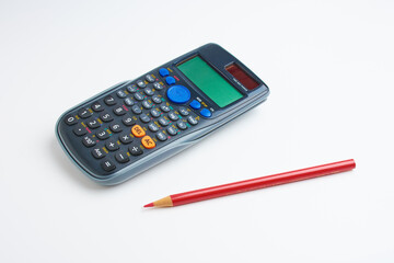 mathematical calculator and red pencil 