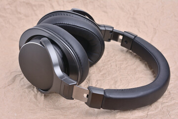 Wireless full-size, professional music headphones on a background of craft paper